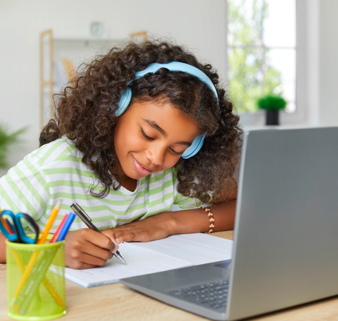 Girl at her home wearing headphones working on live, virtual math lessons.