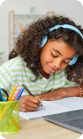 Girl at her home wearing headphones working on live, virtual math lessons.