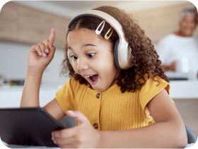Student wearing headphones is excited during virtual math tutoring session.