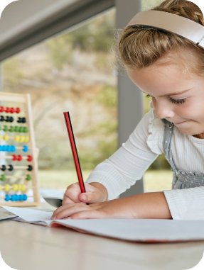 Young female student works independently during at her tablet with abacus.