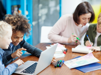 Two groups of students work in a blended classroom model of virtual math tutoring.